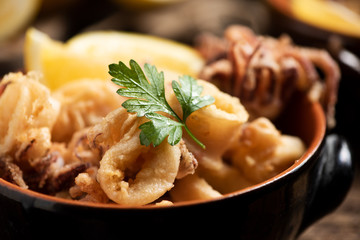 Traditional Italian fried calamari and lemon slice