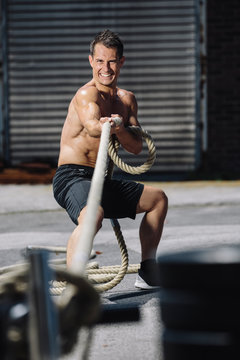 CrossFit athlete pulling rope