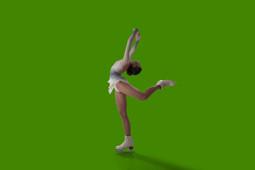 Figure skating girl isolated on green background.