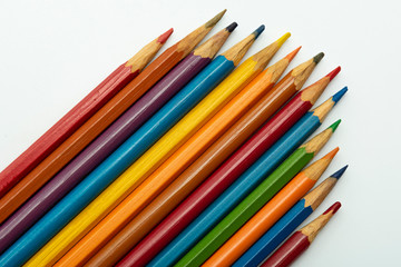 multicolored pencils made of rainbow color on a white background close-up