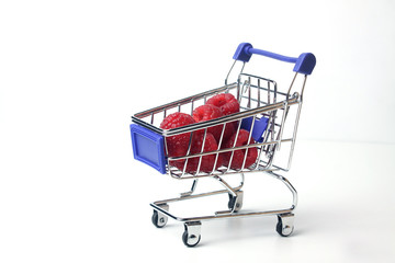 shopping cart with raspberry isolated on white background