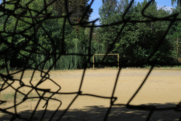 Old football field through the fence