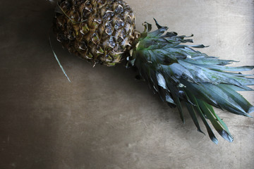 Sliced pineapple on wooden board