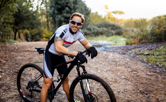 Portrait of smiling mountain biker driving in nature