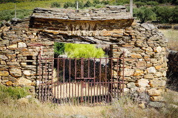 Old metal door of access to a land