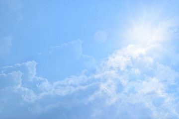 Blue cloudy sky with harsh sunshine