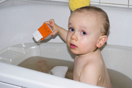 Toddler bathing in tub