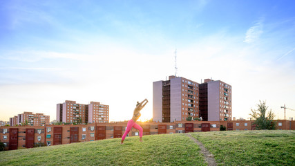Woman performing abdominal hypopressive exercises outdoors
