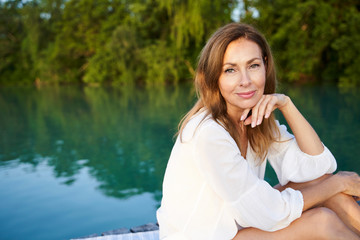 Portrait of mature woman at a lake