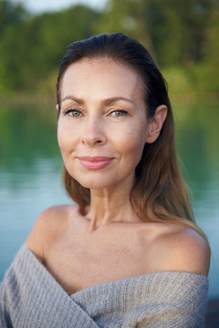 Portrait of mature, woman at a lake
