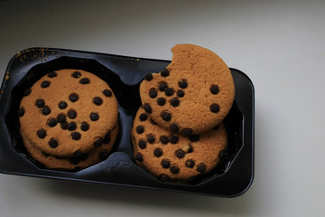 Cookies with chocolate on the windowsill