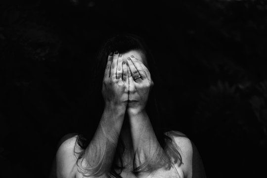 Double Exposure Portrait Of Woman Face Hiding Behind Hands