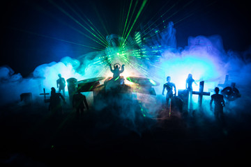 Scary view of zombies at cemetery dead tree, moon, church and spooky cloudy sky with fog, Horror Halloween concept. Toned