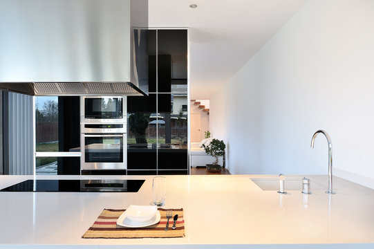 Modern kitchen with extractor hood and iron faucet