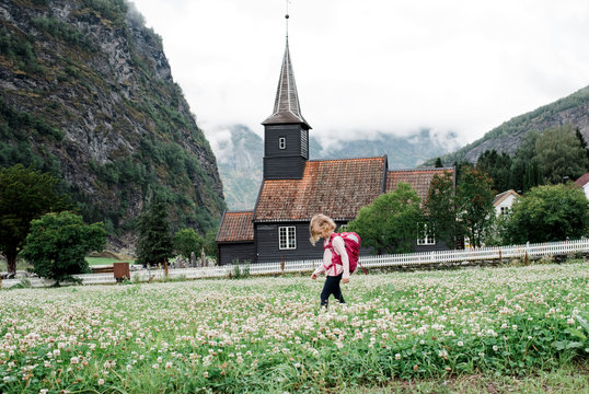 Girl backpacking outside a beautiful church  fjord in Flam, Norway