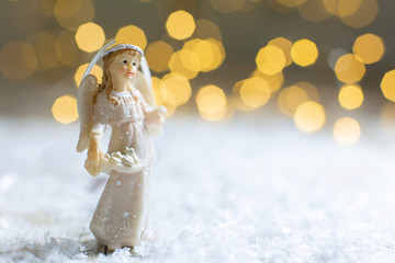 Decorative Christmas-themed figurines. Statuette of a Christmas angel. Christmas tree decoration....