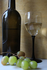Bottle of wine, glass and grapes
