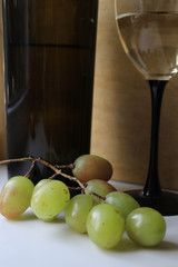 Bottle of wine, glass and grapes