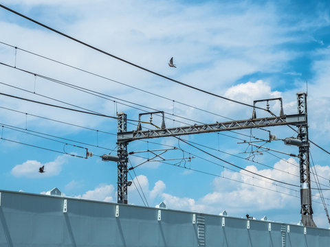 Power line passing against cloudy sky