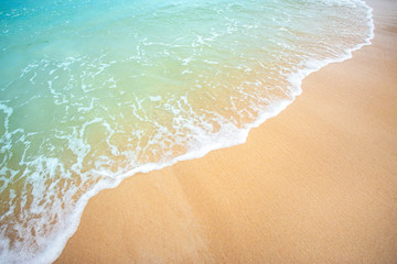Soft wave of blue ocean selective focus on sandy beach ,On sandy beach background. Travel concept