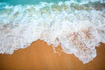Soft wave of blue ocean selective focus on sandy beach ,On Sandy Beach Background