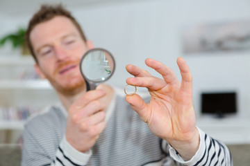 looking at a ring using magnifying glass