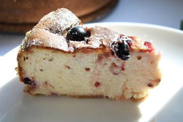 A piece of cheese cake on a white plate