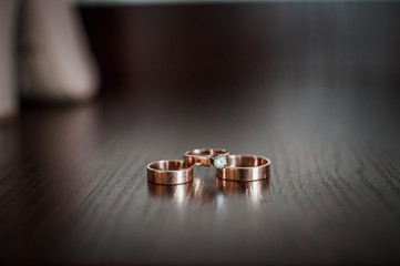Three gold wedding rings on the table