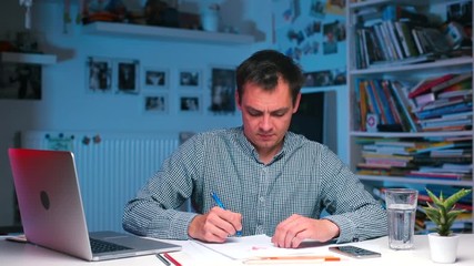 Office worker doing work items at the table.