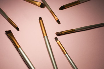 Makeup brushes on pink background