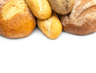Heap of different loaf of bread on white. Space for text.