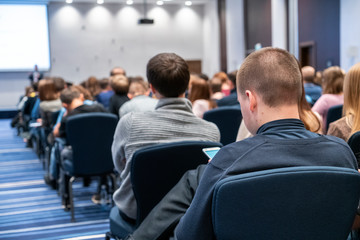 Image of a conference that takes place in a large conference room, workshop for young professionals, training in a large conference room, adult training