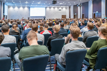 Image of a conference that takes place in a large conference room, workshop for young professionals, training in a large conference room, adult training