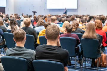 Image of a conference that takes place in a large conference room, workshop for young professionals, training in a large conference room, adult training