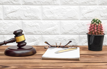 Workplace with judge gavel and notepad.