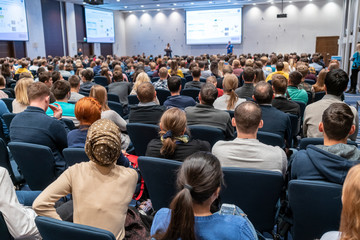 Image of a conference that takes place in a large conference room, workshop for young...