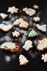 Christmas gift gingerbread on dark background.  Christmas gingerbread cookies with icing sugar. Top view