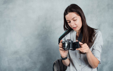 photographer takes the photo. Young successful woman press photographer