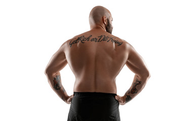 Fototapeta premium Athletic bald, tattooed man in black shorts is posing isolated on white background. Close-up portrait.