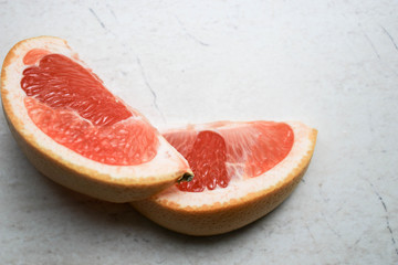 Sliced grapefruit on a stone table