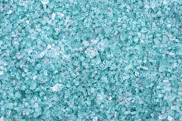Fototapeta na wymiar Fragments of blue glass. Small and sharp fragments of broken glass. cullet for creation of new glass are ready to be remelted. lot of particles of shattered glass. Garbage recycling. Ecology, trash