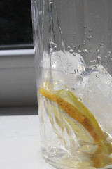 Glass with lemon, ice and water
