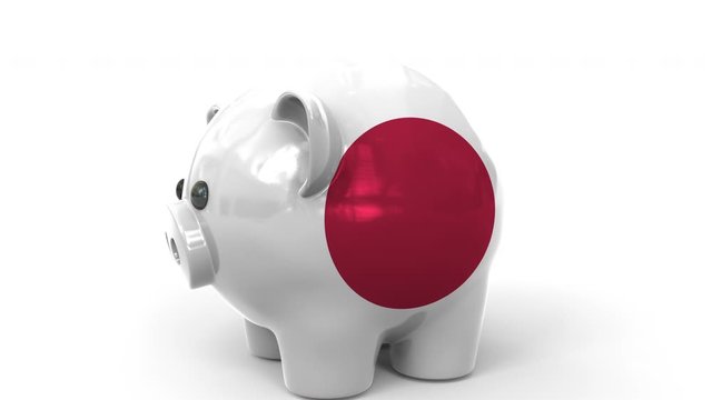 Coins fall into piggy bank painted with flag of Japan. National banking system or savings related conceptual 3D animation