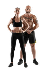 Fototapeta na wymiar Athletic man in black shorts and sneakers with brunette woman in leggings and top posing isolated on white background. Fitness couple, gym concept.