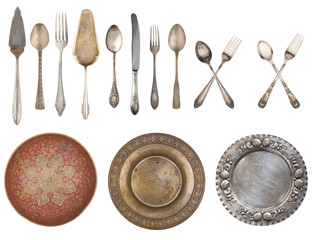 White plates and vintage spoons and fork on color wooden background