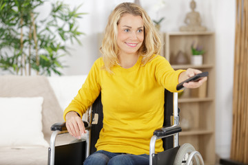 Fototapeta premium woman in wheelchair watching a cooking programme