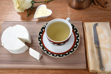 cup of tea with cheese on wooden table, brazilian breakfast