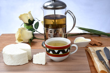 cup of tea with cheese on wooden table, brazilian breakfast