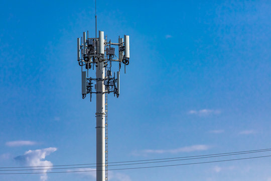 A low angle view of a cell site tower for broadcasting mobile data and communication signals, commonly associated with EMF or electromagnetic field pollution.