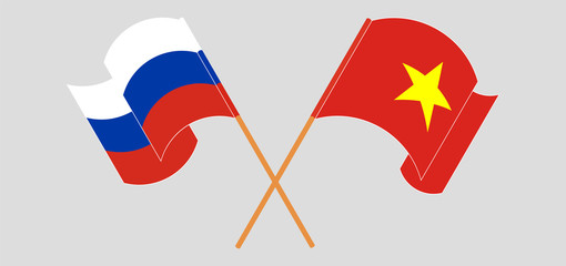 Crossed and waving flags of Vietnam and Russia